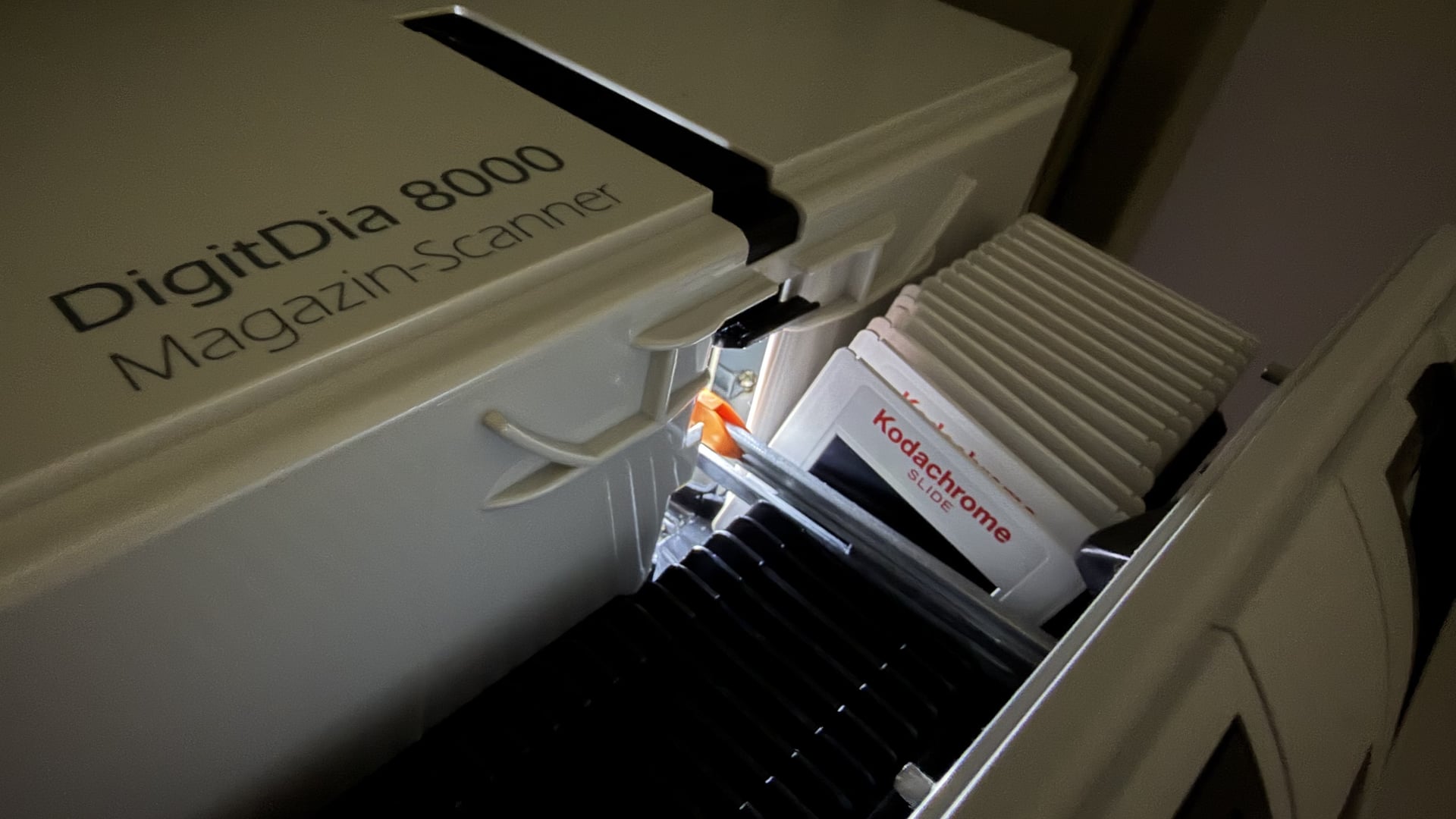 A DigitDia 8000 magazine scanner ingests a tray of Kodachrome slides — analogue originals translated into high-resolution archival masters.