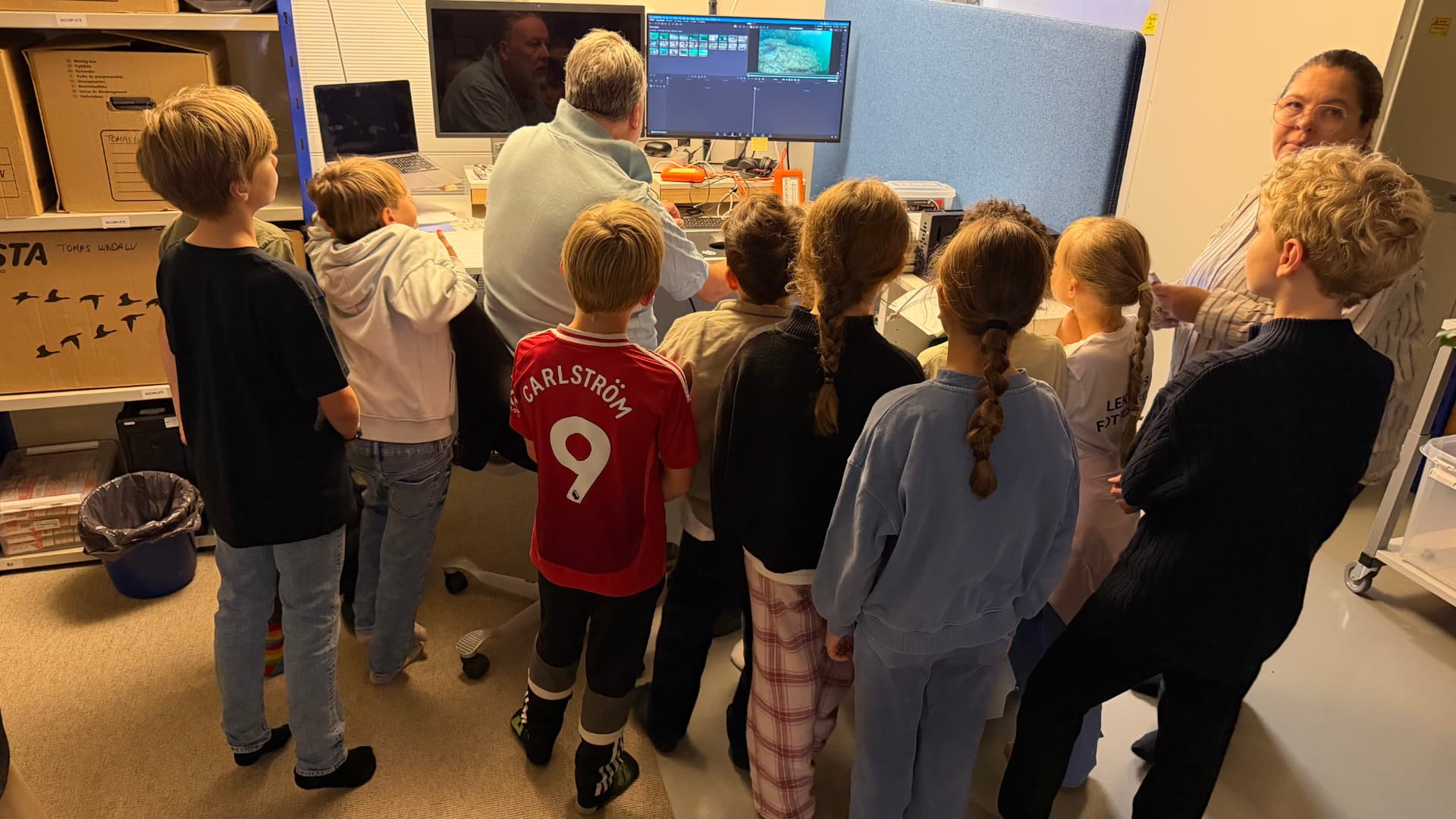 Students from Kungsholmens Friskola watch historic underwater film at Ocean Archive.