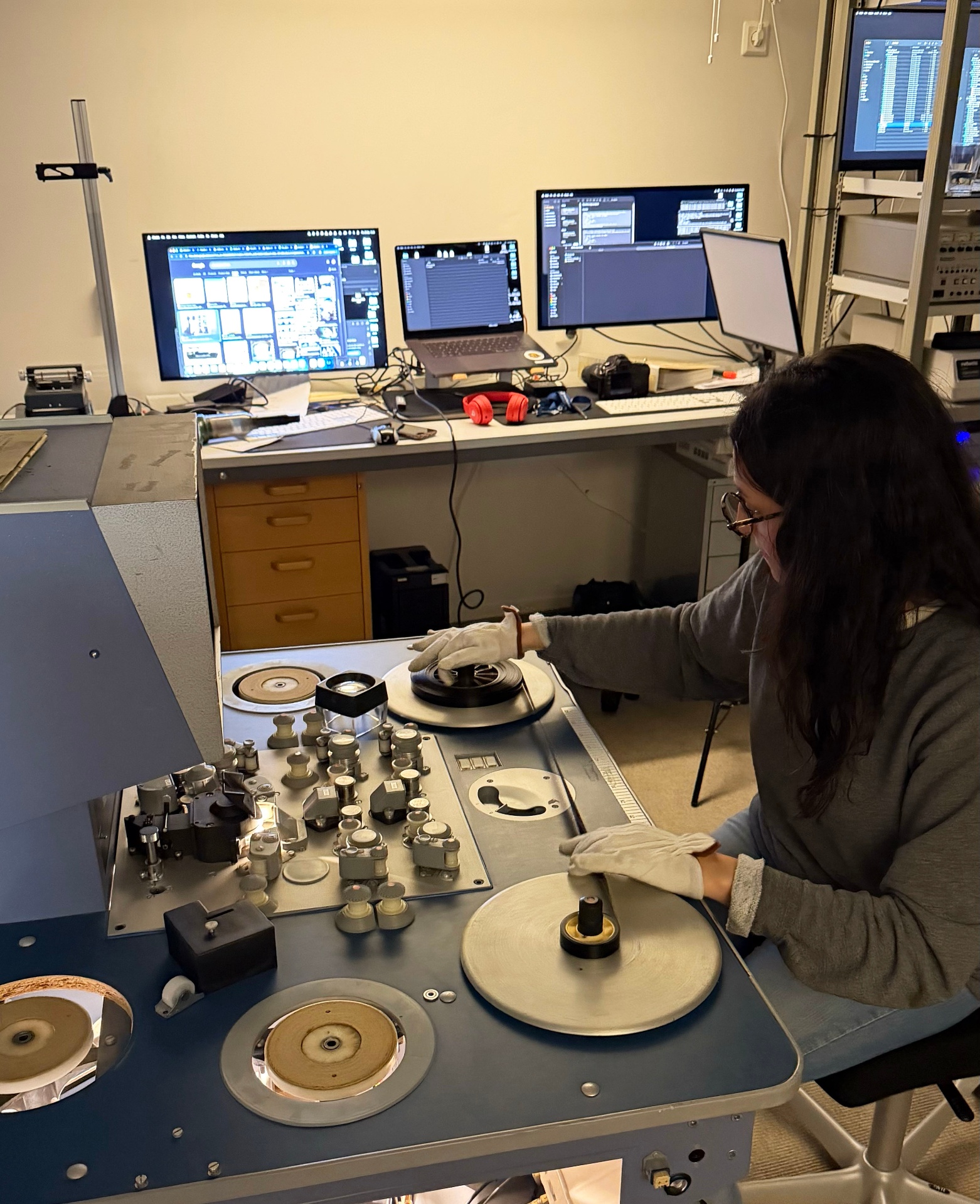 Our archivist inspects 16mm film from the Börjeson collection on the editing table. 