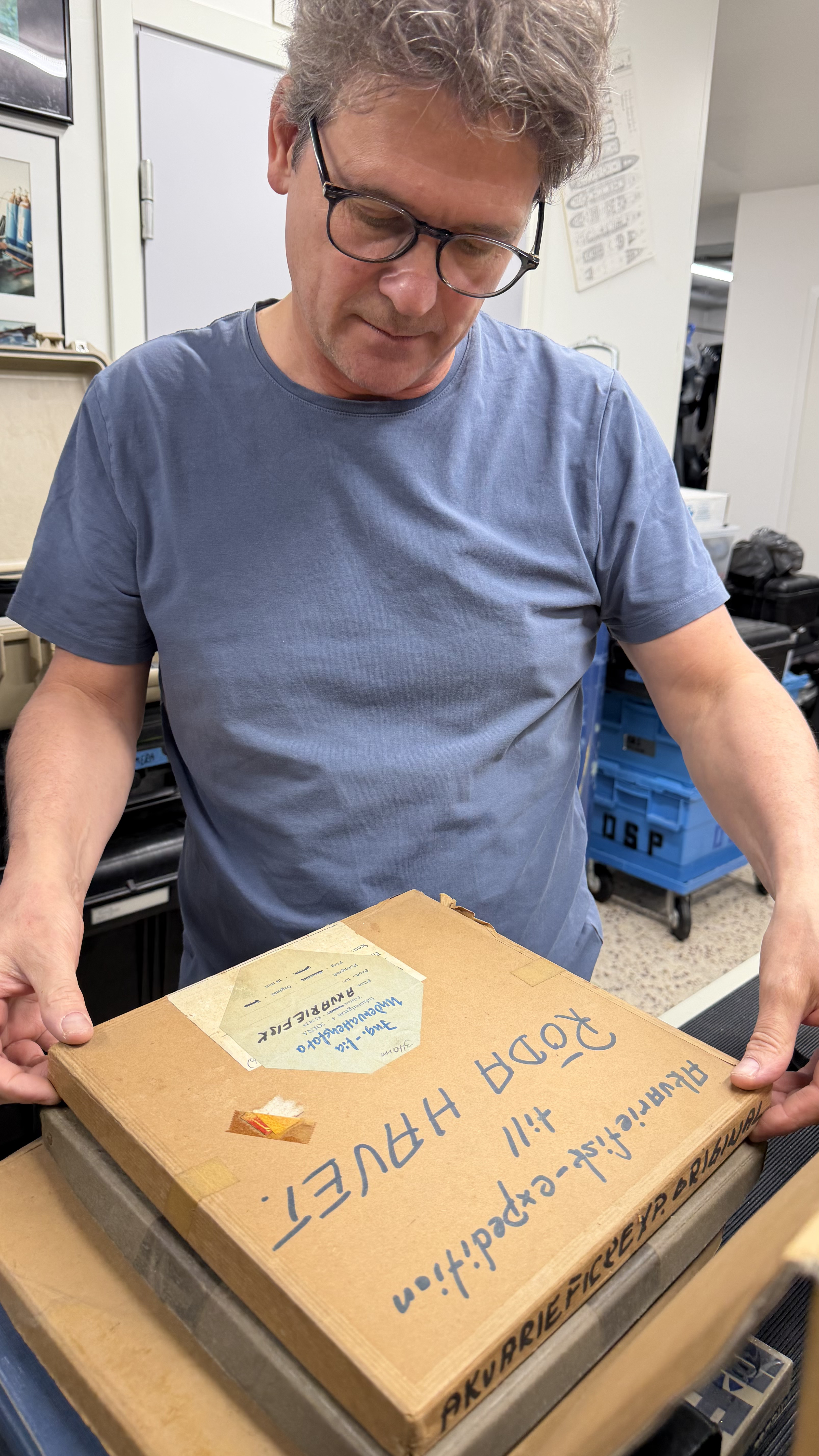 Eric Börjeson inspects film from his father's collection at the Ocean Archive facility.
